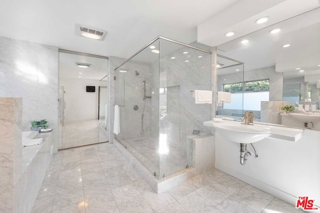 bathroom featuring sink and a shower with shower door