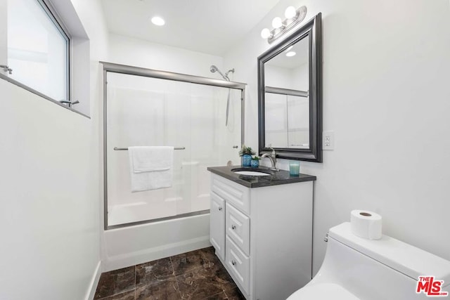 full bathroom featuring vanity, toilet, and enclosed tub / shower combo