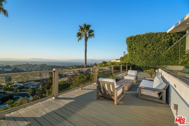 wooden deck with outdoor lounge area and a mountain view