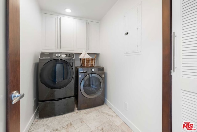 clothes washing area featuring cabinets, independent washer and dryer, and electric panel