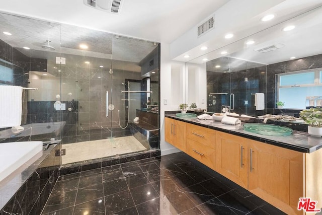 bathroom featuring vanity, tile walls, and independent shower and bath