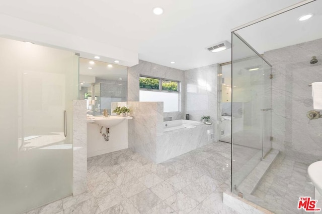 bathroom featuring separate shower and tub