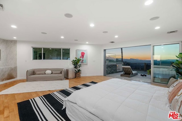 bedroom with access to outside and light hardwood / wood-style flooring