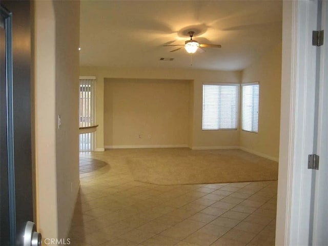 carpeted spare room with ceiling fan