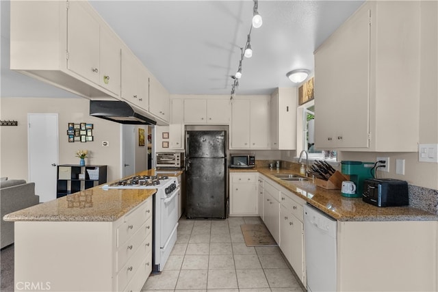 kitchen with rail lighting, white appliances, sink, light stone countertops, and white cabinetry