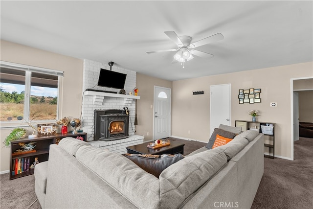 carpeted living room with a brick fireplace and ceiling fan