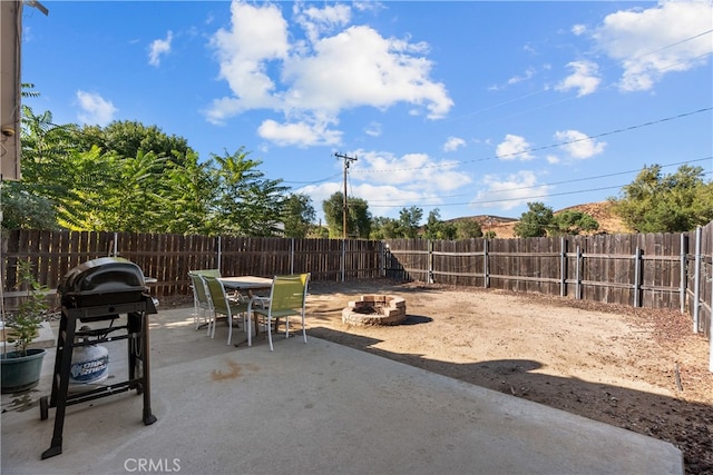 view of patio / terrace with a grill and an outdoor fire pit