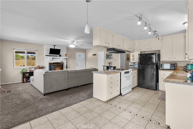 kitchen featuring light tile patterned flooring, ceiling fan, decorative light fixtures, white range oven, and black refrigerator