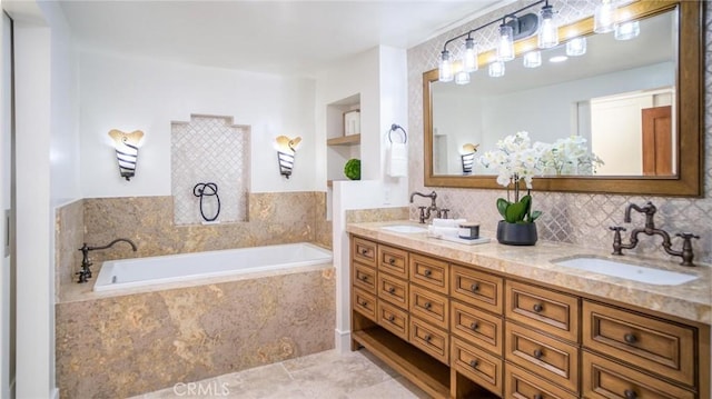 bathroom with tile patterned floors, vanity, a relaxing tiled tub, and built in shelves