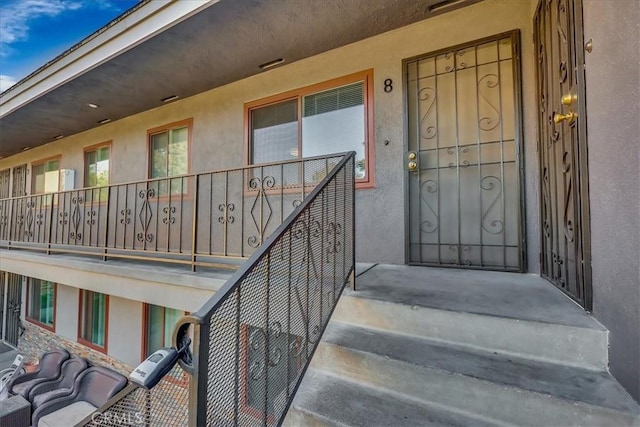 entrance to property with a balcony