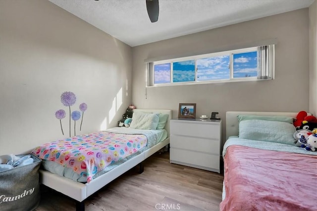 bedroom with light wood-type flooring and ceiling fan