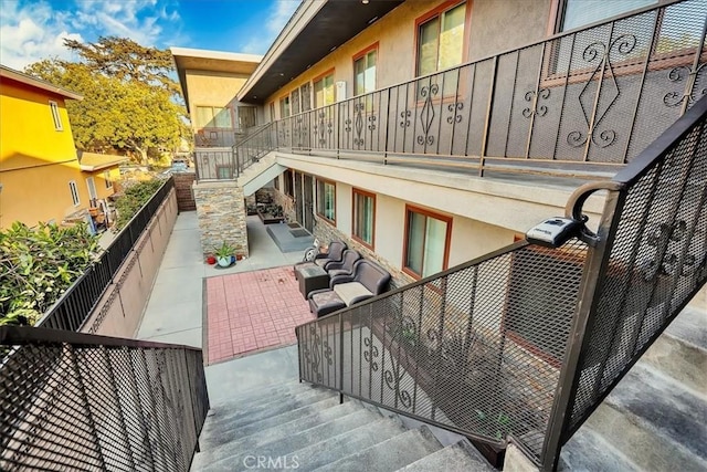 balcony with an outdoor living space and a patio