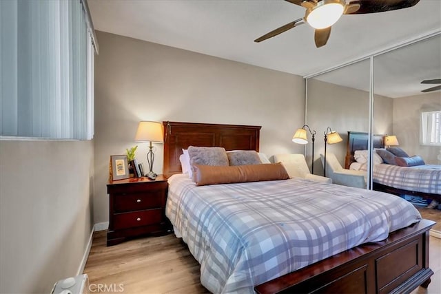 bedroom with ceiling fan, light hardwood / wood-style flooring, and a closet