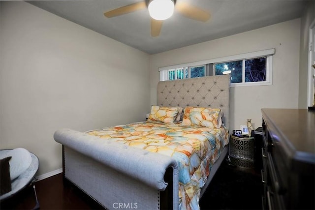 bedroom with ceiling fan and dark hardwood / wood-style floors