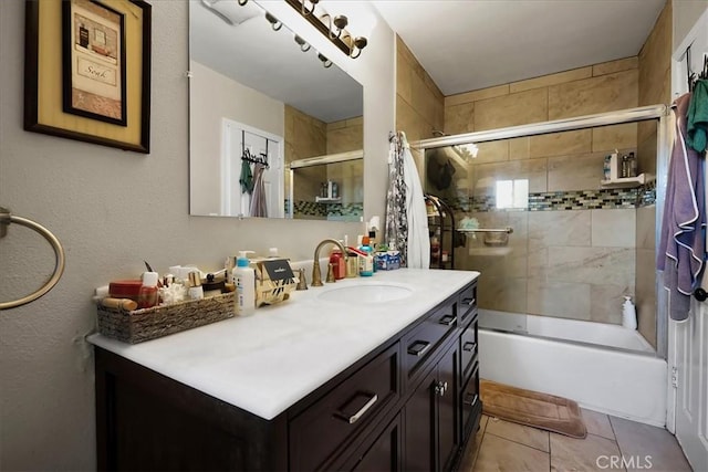 bathroom with tile patterned flooring, vanity, and tiled shower / bath combo