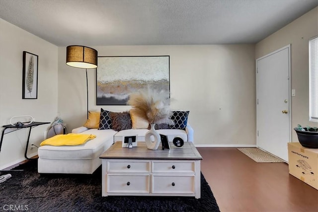 sitting room featuring dark colored carpet