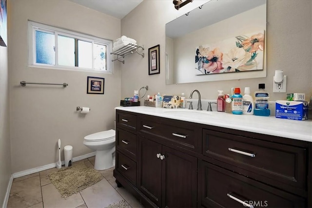 bathroom with tile patterned floors, vanity, and toilet