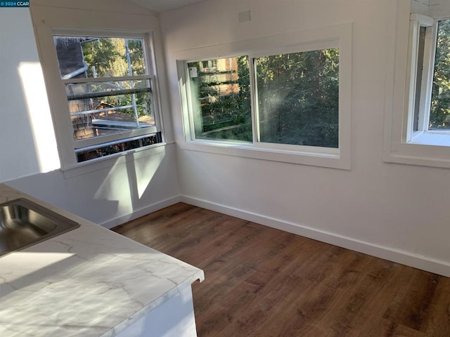 dining area with dark hardwood / wood-style floors and sink