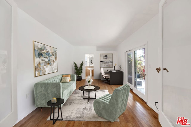 living room featuring hardwood / wood-style flooring and lofted ceiling