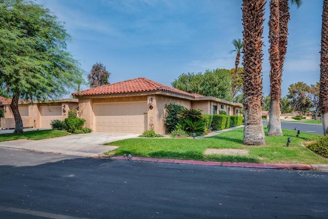 view of front of home featuring a garage and a front lawn