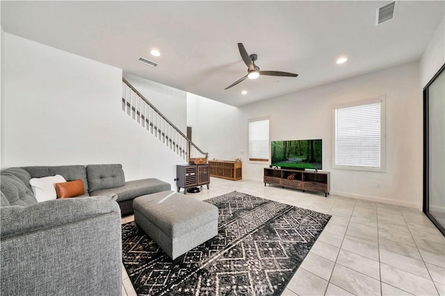 tiled living room featuring ceiling fan