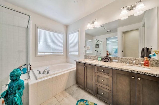 bathroom with tile patterned floors, vanity, and separate shower and tub