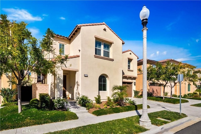 mediterranean / spanish-style home featuring a garage