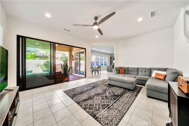 living room with ceiling fan and light tile patterned floors