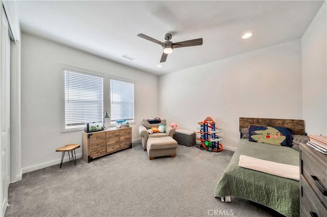 carpeted bedroom with ceiling fan and a closet