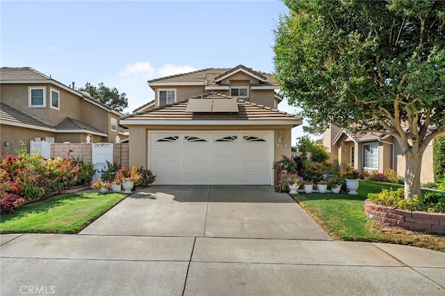 view of property with solar panels, a garage, and a front lawn