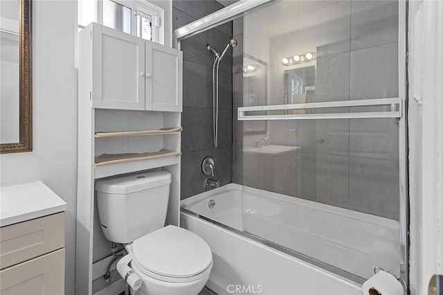 full bathroom featuring vanity, enclosed tub / shower combo, and toilet