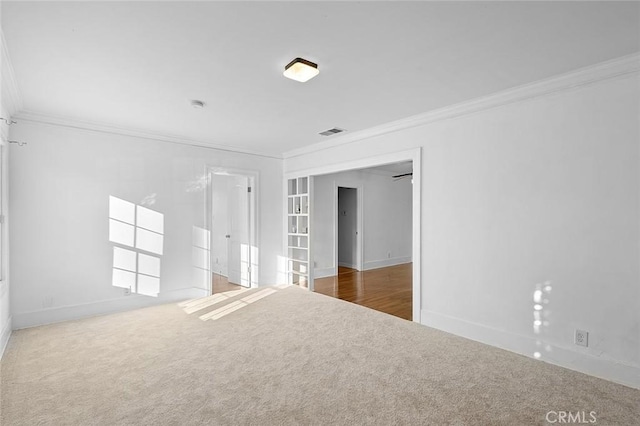 carpeted spare room with crown molding