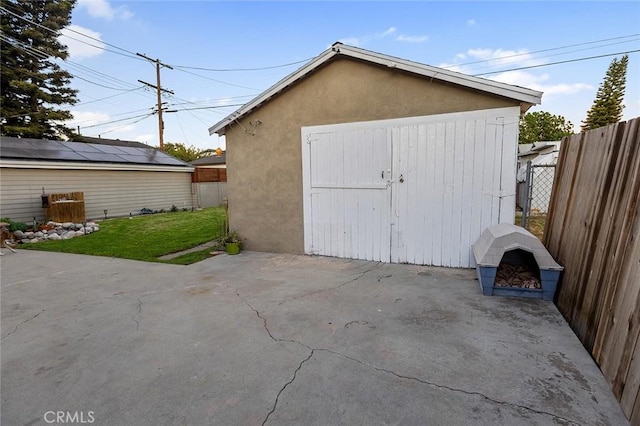 view of outbuilding featuring a yard and an outdoor fire pit