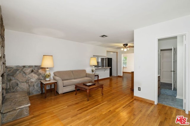 living room featuring ceiling fan and light wood-type flooring