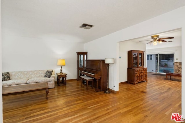 living room with ceiling fan and hardwood / wood-style floors