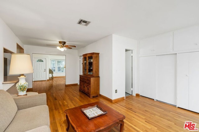 living room featuring ceiling fan and hardwood / wood-style floors