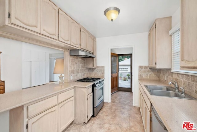 kitchen featuring tasteful backsplash, light brown cabinetry, sink, and stainless steel appliances