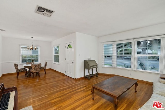 living room featuring hardwood / wood-style floors and a notable chandelier