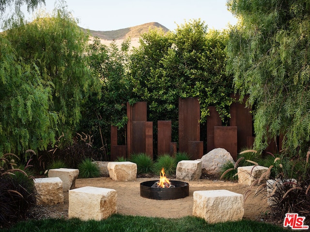 view of yard with a fire pit and a mountain view