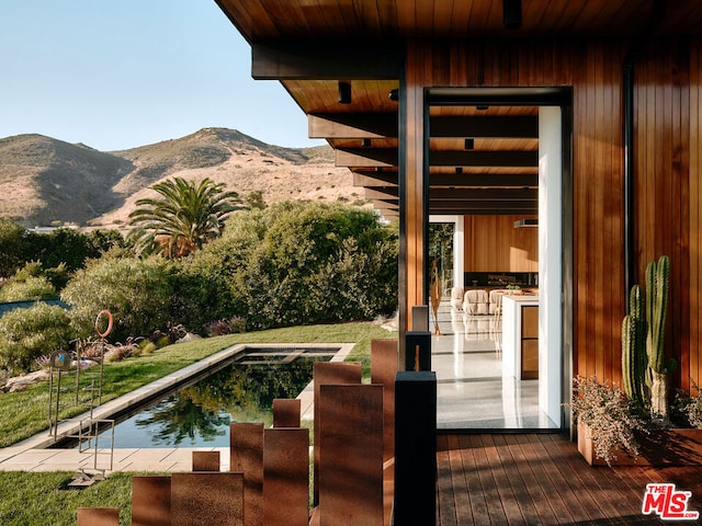 view of swimming pool featuring a mountain view and a patio