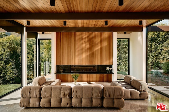 home theater with plenty of natural light, wooden ceiling, and beam ceiling