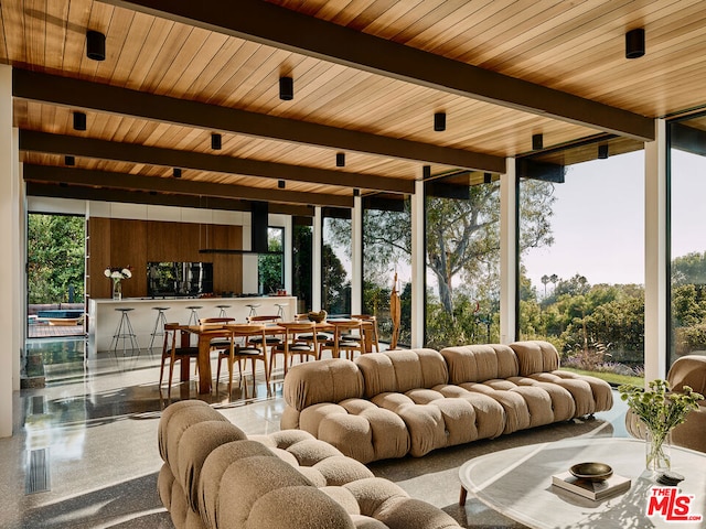 sunroom / solarium featuring beam ceiling and wooden ceiling