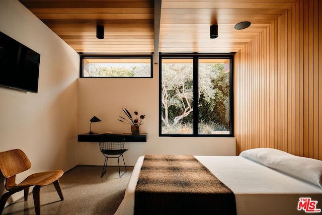 carpeted bedroom featuring wood walls and wooden ceiling