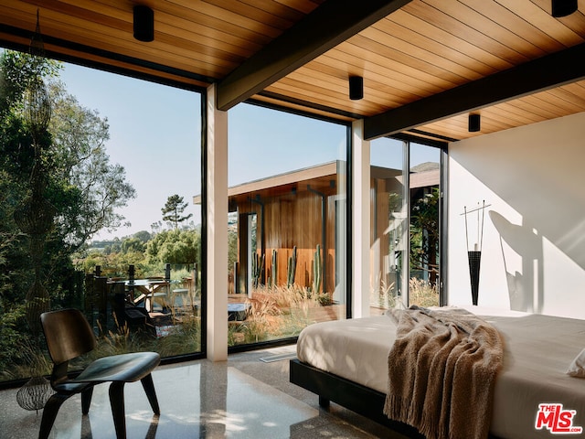 bedroom featuring a wall of windows and multiple windows