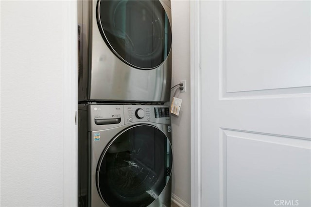 laundry room with stacked washer / dryer