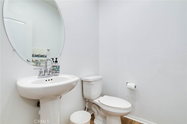 bathroom with wood-type flooring and toilet