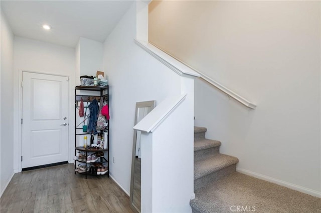 stairs with hardwood / wood-style floors