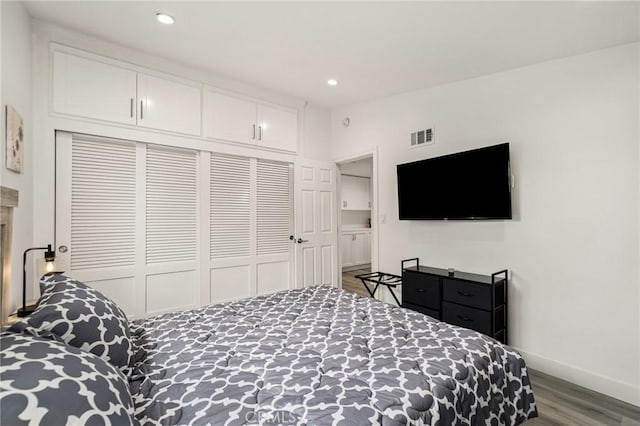 bedroom featuring wood-type flooring and a closet