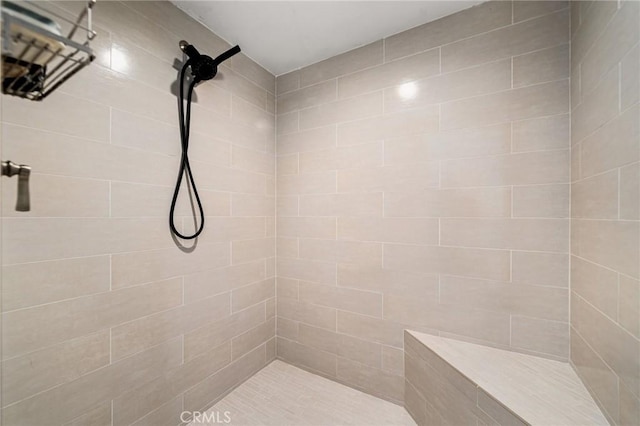 bathroom featuring a tile shower