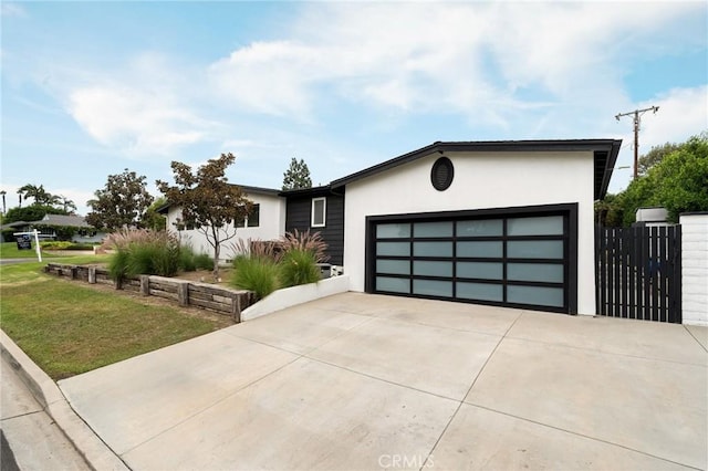 view of front of property with a garage and a front yard